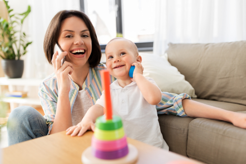 Parent on the phone and child copies with block